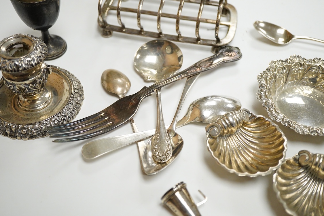 A collection of small silver, to include a late Victorian seven bar toast rack, by Edward Gilbert, London, 1887, length 13.3cm, a late Victorian bowl, pair of shell salts, nut dish, egg cup, Georgian chamberstick(part of